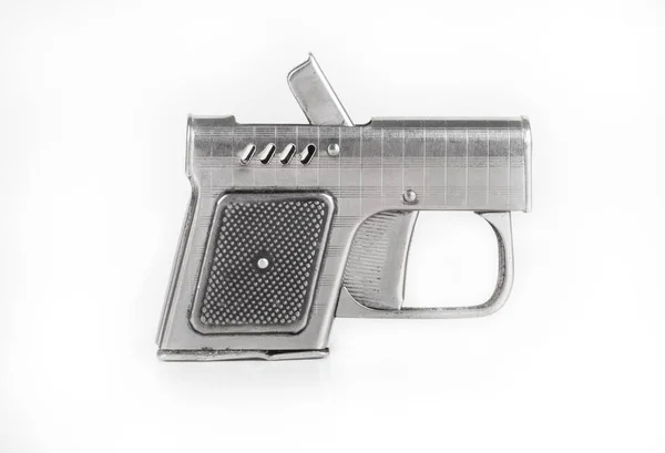 Encendedor en forma de pistola sobre un fondo claro — Foto de Stock