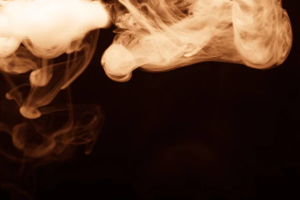 Cloud of smoke on black background. Selective focus. Toned — Stock Photo, Image