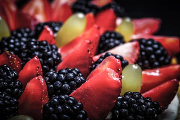 Oberseite des Keks hausgemachte Kuchen mit Sahne und Beeren auf schwarzem Bac — Stockfoto