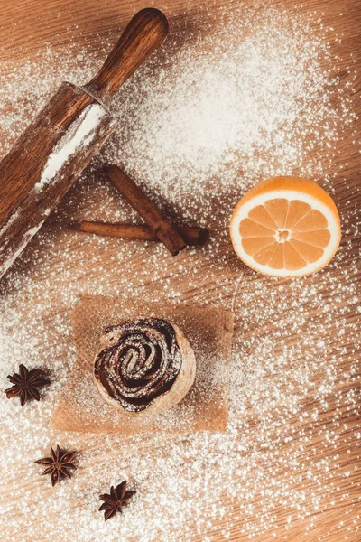 Homemade pastries on a light wooden table with flour. Toned