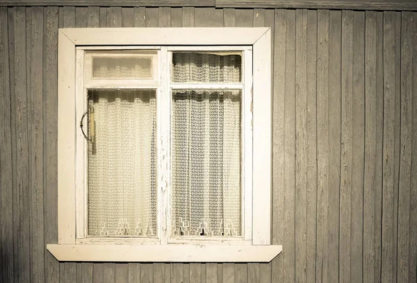 Window on the old wooden houses painted wall. Toned — Stock Photo, Image