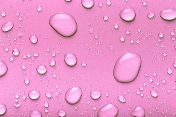 Gotas de água em um fundo a cores. Rosa. Tonificado — Fotografia de Stock