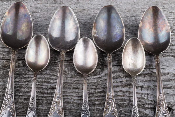 Old spoon of german silver on a gray wooden background — Stock Photo, Image