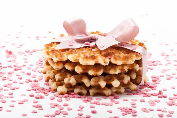 Waffles tied with a ribbon and sprinkled with sweet heart — Stock Photo, Image