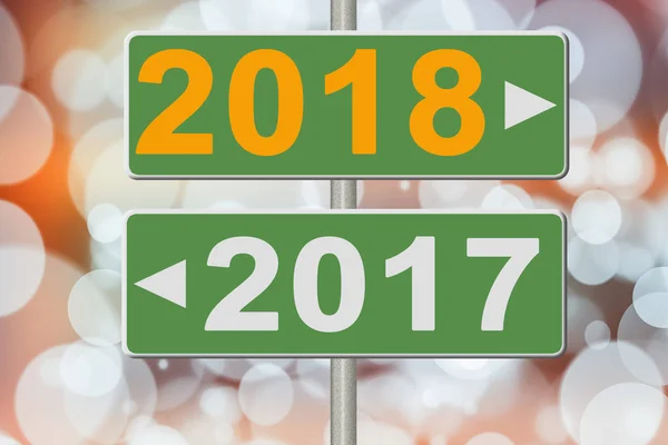 Знаки 2017 і 2018 на розмитому тлі. Колаж — стокове фото