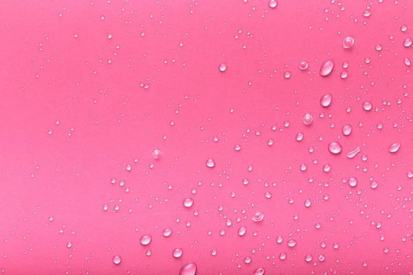 Gotas de agua sobre un fondo de color. Rosa. Tonificado —  Fotos de Stock