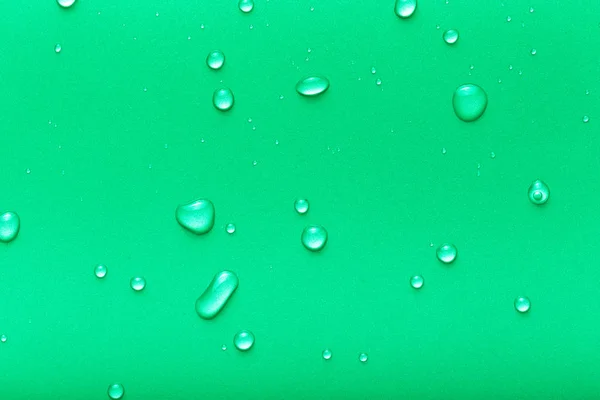 Drops of water on a color background. Green. Toned — Stock Photo, Image