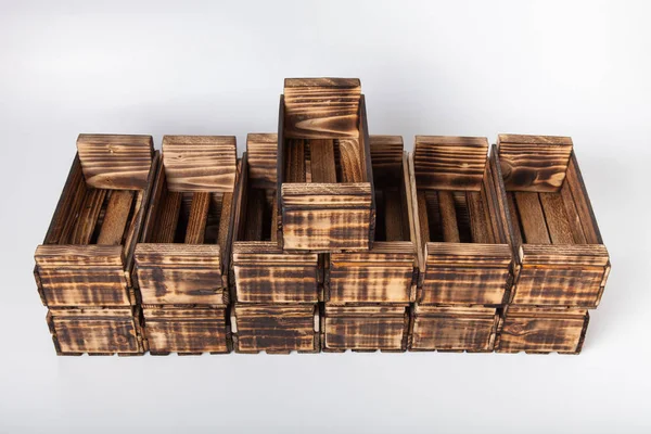 Handmade burned wooden boxes on a light background — Stock Photo, Image