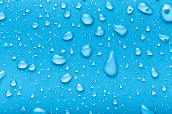 Σταγόνες νερού σε φόντο χρώματος. Μπλε. Γραμμένο — Φωτογραφία Αρχείου