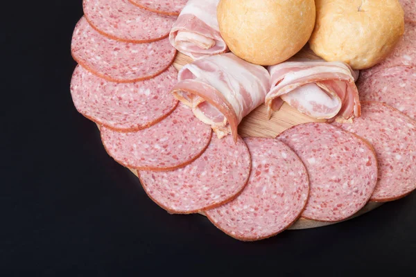 Sausage and bread on a dark  table. Shallow depth of field. Sele — Stock Photo, Image