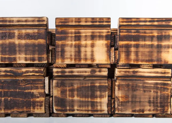 Caixas de madeira queimadas artesanais em um fundo leve — Fotografia de Stock