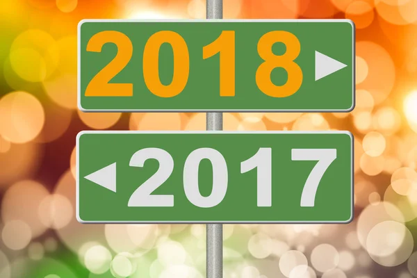 Знаки 2017 і 2018 на розмитому тлі. Колаж — стокове фото