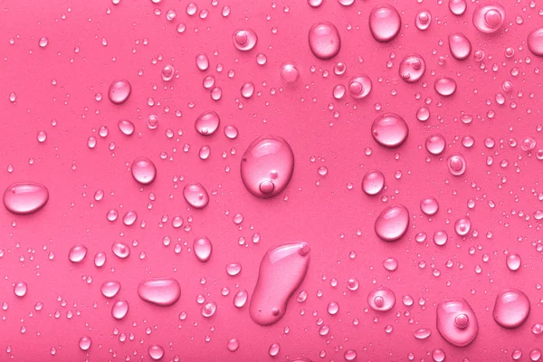 Gotas de água em um fundo a cores. Rosa. Tonificado — Fotografia de Stock