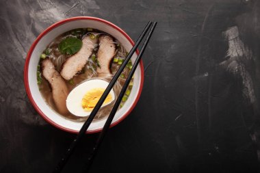 Bir kase pirinç eriştesi, et ve sebzeli kompozisyon.