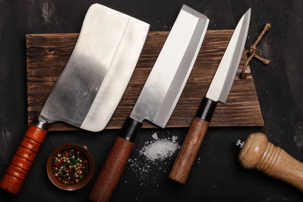 Messer und Gewürze auf einem dunklen Tisch — Stockfoto