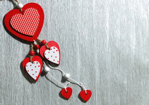 Valentine's Day, wedding, love. White and red bright wooden hearts on a silvery gray background with an empty space for writing congratulations or invitations. — Stock Photo, Image