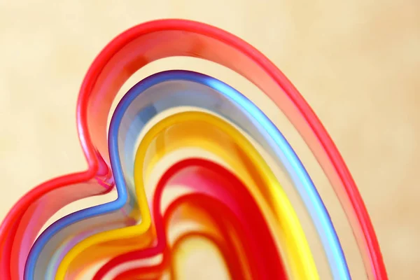 Abstract bright multicolored iridescent rectangular beige background with wavy lines of different shades in the shape of a heart. — Stock Photo, Image