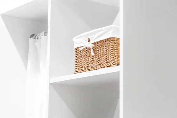 Details and elements of the interior, domestic life. Organization of home space, order and cleanliness in the closet for things. Box for neat storage of clothes. Furniture in the wardrobe