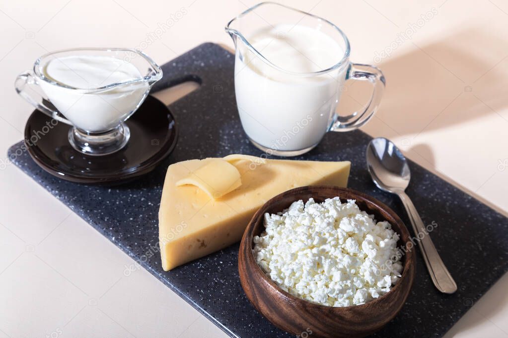 Food is a source of calcium, magnesium, protein, fats, carbohydrates, balanced diet. Dairy products on the table: cottage cheese, sour cream, milk, cheese, contain casein, albumin, globulin, free lactose