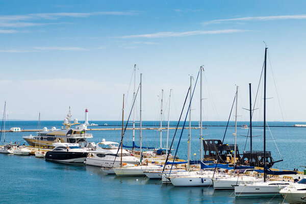 Yachts are moored to the pier in the sea port