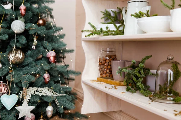 Decorative christmass tree with kitchen shelf. — Stock Photo, Image