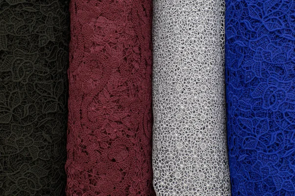 A lot of fabric rolls. Bolts of lace fabric blue, gray, brown colors — Stock Photo, Image