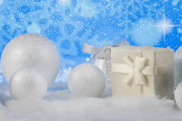 Новорічна композиція з подарунковою або подарунковою коробкою та декоративними сніжками на фоні святкових вогнів — стокове фото