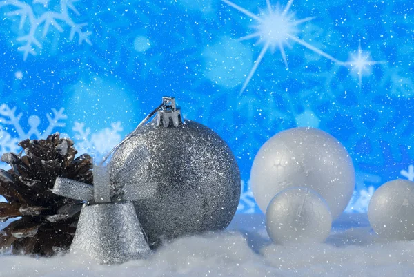 Christmas composition with pine cone and decorative snowballs against holiday lights background — ストック写真