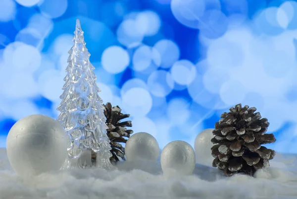 Christmas composition with Christmas tree, pine cone and decorative snowballs against holiday lights background — ストック写真