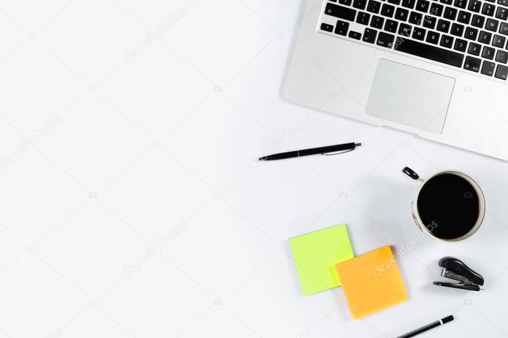 Working table top view, flat lay. Business items on a white table, laptop, phone, pens, stickers. Copy Space, Concept of business attributes.