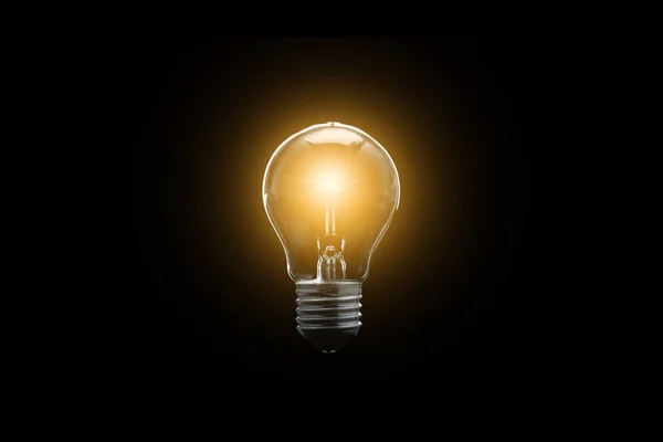 電球は、暗い背景に光っています。概念は成功したアイデア. — ストック写真