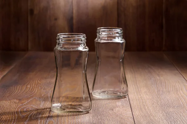 glass empty jars on a wooden background