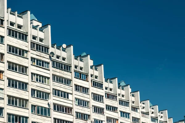 Multi-storey building in the form of steps against the blue sky