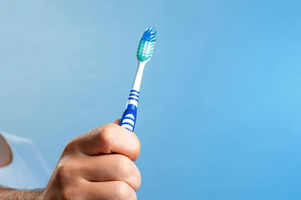 Blue Toothbrush Close Hand Blue Background Hygiene Oral Cavity — Stock Photo, Image