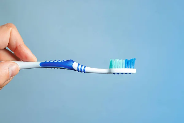 Blue Toothbrush Close Hand Blue Background Hygiene Oral Cavity — Stock Photo, Image