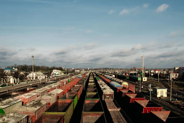 A lot of freight rail cars, a cargo distribution station. Staging post. Large parking of trains.