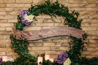 Yeşil çelenk yazmak için bir plaket üzerine duvarda asılı