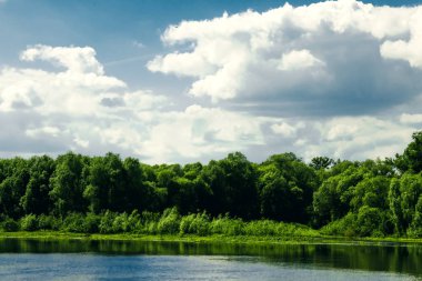 Güzel bir yaz kırsalında nehir ve mavi gökyüzünde bulutlar. - Rusya. Ural. Sloboda Köyü