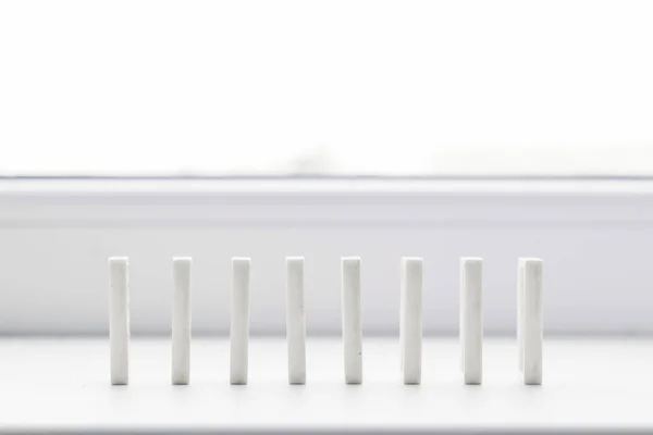 White domino, domino principle, on white background
