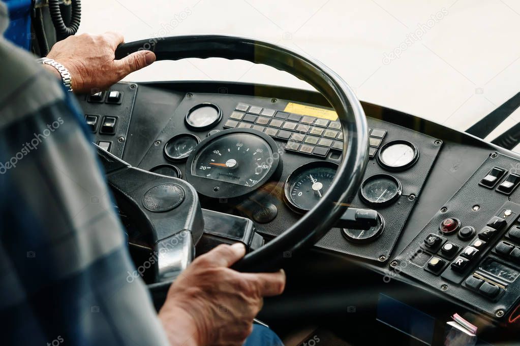 Driver man behind the wheel view from the back, close-up hands