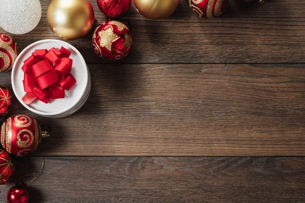 Christmas ornaments and gifts on a wooden table. Holidays christmas background. Copy space for text or design. View from above.