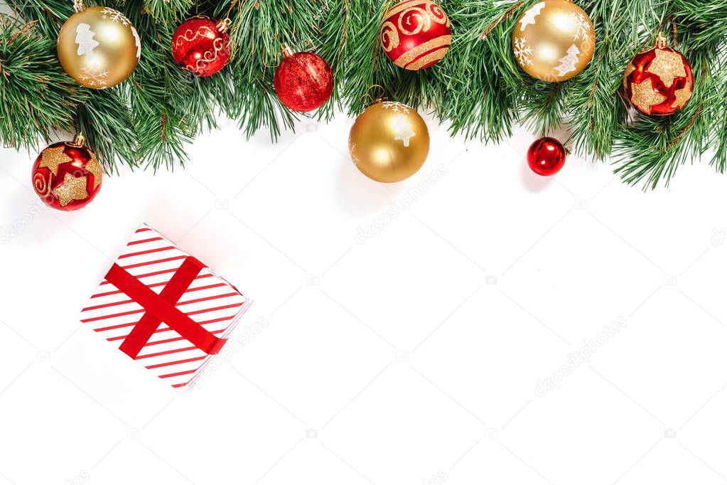 Branches of spruce with gold and red balls and gifts, isolated on white background. Isolate.