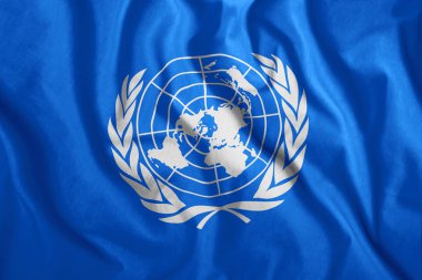 The UN flag is flying in the wind. Colorful UN flag. Symbol, unification. clipart