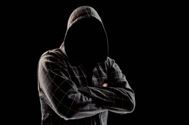 Silhouette of a man in a hood on a black background, his face is not visible, he folded his arms over his chest. The concept of a criminal, incognito, mystery, secrecy, anonymity. clipart
