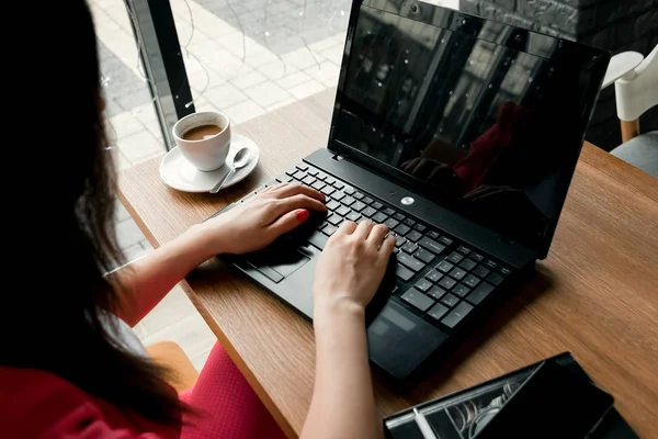 Primer plano escritorio de la oficina. Espacio de trabajo con las manos de la chica, portátil, taza de café. Mujer de negocios . — Foto de Stock