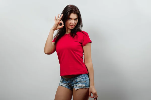 Joven, hermosa chica mostrando las manos gesto ok. Aislado sobre un fondo claro. Diferentes emociones humanas, sentimientos de expresión facial, actitud, percepción, lenguaje corporal, reacción . — Foto de Stock