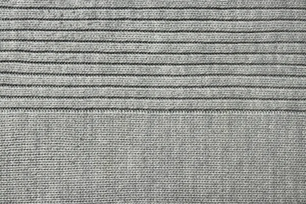 Textuur van grijze gebreide stof, close-up, bovenaanzicht — Stockfoto