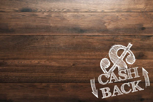 Inskriften Cash Back, en bild av emblemet på en trä bakgrund. Ikon, en symbol för kontantutbetalning. Begreppet business, finance. — Stockfoto