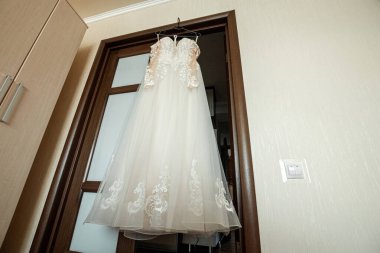 Kompozisyon: Gri mavi bir duvarda, dekorlu ve aksesuarlı bir gelinlik. Evlilik kavramı, aile ilişkileri, düğün aletleri..