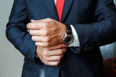 Bir iş adamının elleri, yakın plan, saatin düğmeleri.